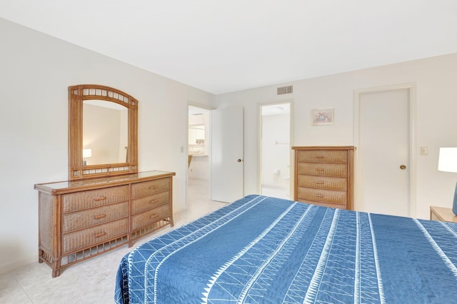 bedroom with visible vents, connected bathroom, and light tile patterned flooring
