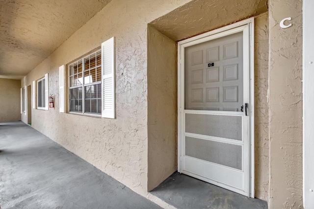 doorway to property with stucco siding