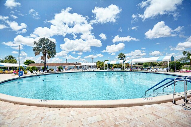 view of swimming pool with a community hot tub