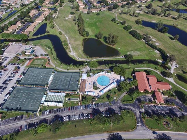 aerial view featuring a water view and view of golf course