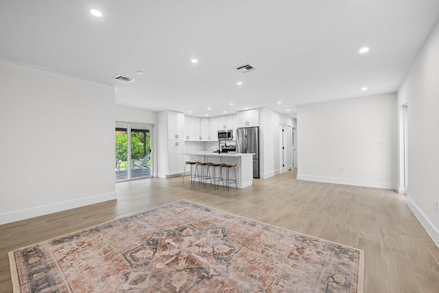 1269 NW 4th St, Boca Raton, FL 33486 - unfurnished living room featuring light wood-style floors, recessed lighting, and baseboards