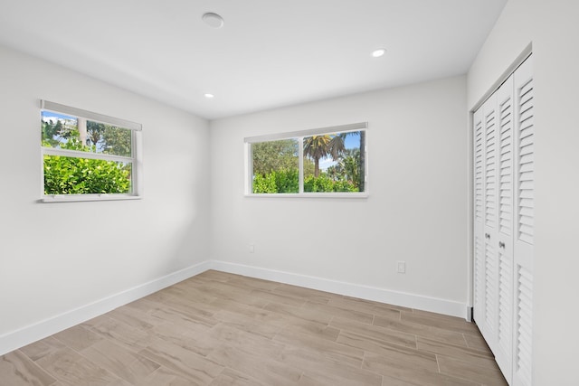 1269 NW 4th St, Boca Raton, FL 33486 - unfurnished bedroom featuring multiple windows, baseboards, recessed lighting, a closet, and light wood-type flooring