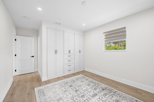 1269 NW 4th St, Boca Raton, FL 33486 - bedroom featuring baseboards, light wood-style flooring, recessed lighting, and two closets