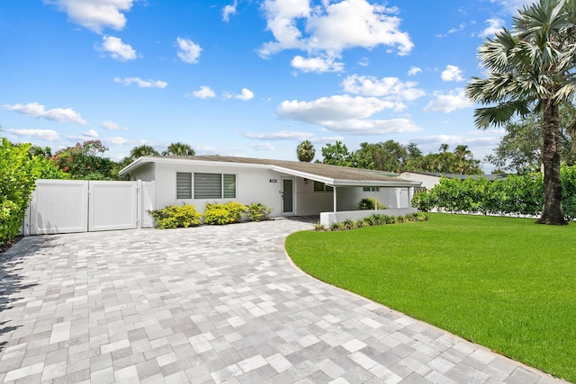 1269 NW 4th St, Boca Raton, FL 33486 - view of front facade with decorative driveway, a gate, and stucco siding