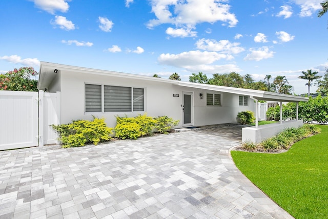 1269 NW 4th St, Boca Raton, FL 33486 - view of front of home with stucco siding and a gate