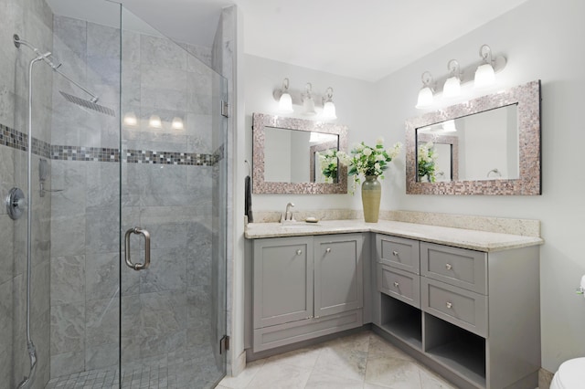full bath featuring vanity and a shower stall