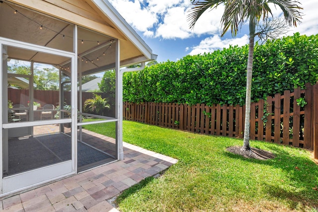 view of yard with fence and a sunroom
