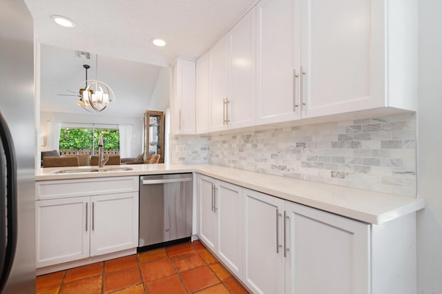 kitchen featuring decorative backsplash, decorative light fixtures, appliances with stainless steel finishes, light countertops, and white cabinets
