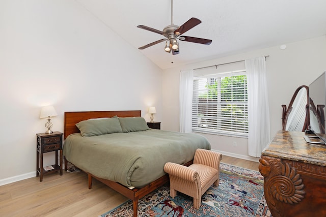 bedroom featuring baseboards, ceiling fan, vaulted ceiling, and light wood-type flooring
