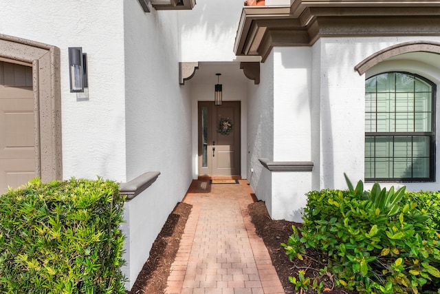 entrance to property featuring stucco siding