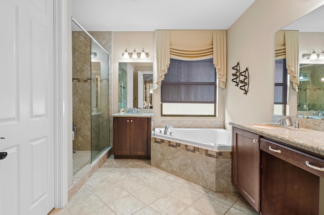 full bath featuring a sink, a garden tub, and a stall shower