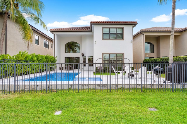 back of house featuring fence, stucco siding, a patio area, a tiled roof, and a yard
