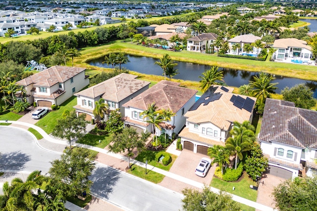 drone / aerial view with a water view and a residential view