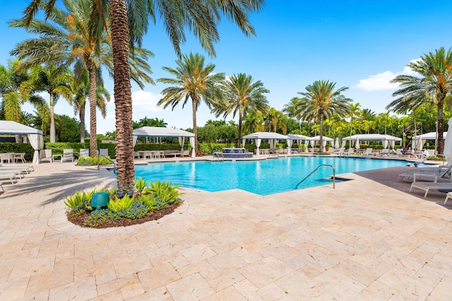 pool with a gazebo and a patio area