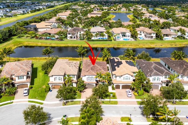 drone / aerial view with a residential view and a water view