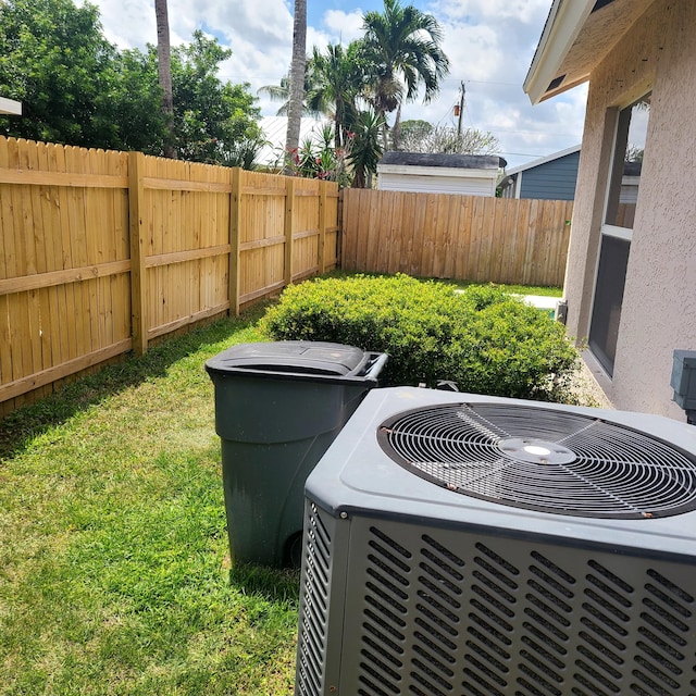 6374 Robinson St, Jupiter, FL 33458 - exterior details featuring central AC and a fenced backyard