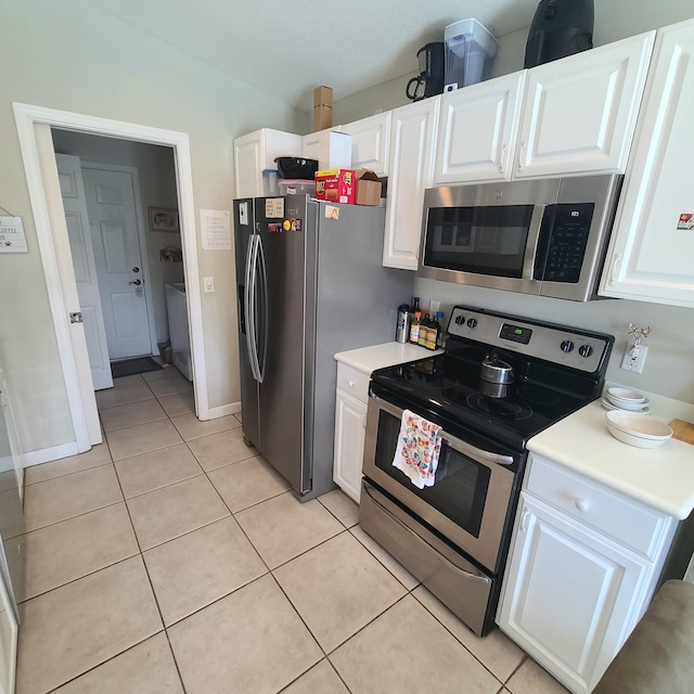 6374 Robinson St, Jupiter, FL 33458 - kitchen with appliances with stainless steel finishes, light tile patterned floors, and white cabinetry