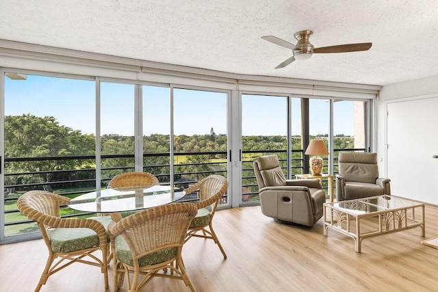 sunroom / solarium with wood finished floors and a textured ceiling