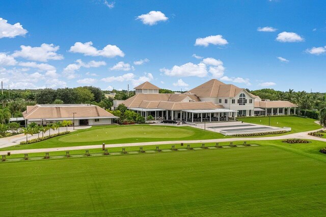view of home's community with a lawn and view of golf course