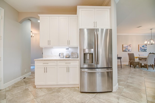 15688 Italian Cypress Way, Wellington, FL 33414 - kitchen featuring stainless steel refrigerator with ice dispenser, baseboards, ornamental molding, and arched walkways