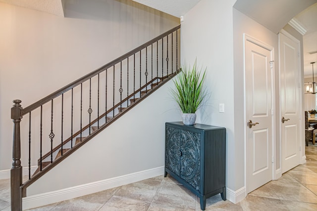 15688 Italian Cypress Way, Wellington, FL 33414 - stairs featuring arched walkways and baseboards