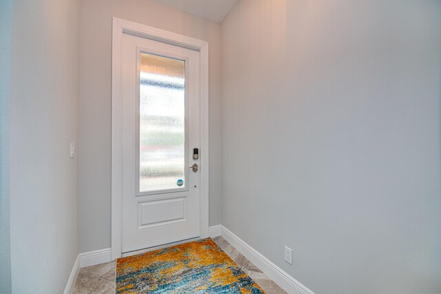 15688 Italian Cypress Way, Wellington, FL 33414 - entryway featuring a healthy amount of sunlight and baseboards