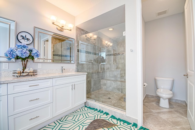15688 Italian Cypress Way, Wellington, FL 33414 - bathroom with visible vents, tile patterned flooring, a stall shower, vanity, and toilet