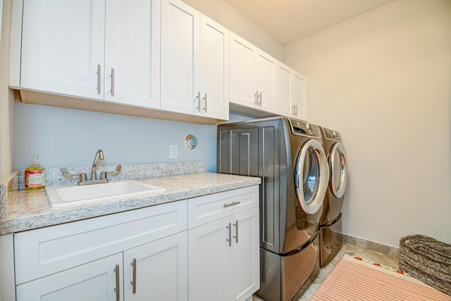15688 Italian Cypress Way, Wellington, FL 33414 - laundry area featuring washing machine and dryer, cabinet space, a sink, baseboards, and light tile patterned floors