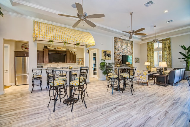 15688 Italian Cypress Way, Wellington, FL 33414 - interior space with ceiling fan, visible vents, crown molding, a tray ceiling, and light wood-style flooring