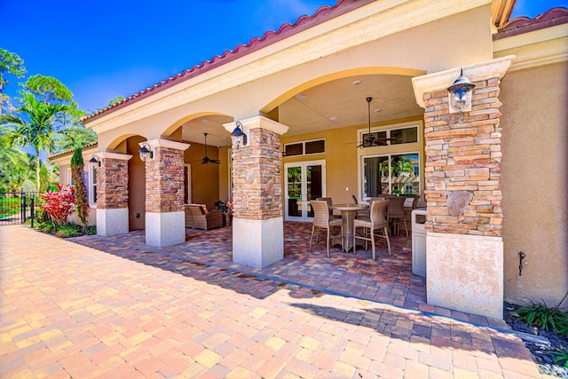 15688 Italian Cypress Way, Wellington, FL 33414 - view of patio / terrace featuring fence, outdoor dining space, ceiling fan, and french doors