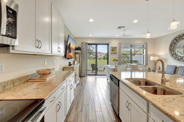 kitchen featuring white cabinets, stainless steel appliances, and a sink