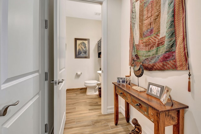 interior space with baseboards and light wood-type flooring