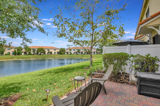 exterior space featuring a water view, fence, and a residential view