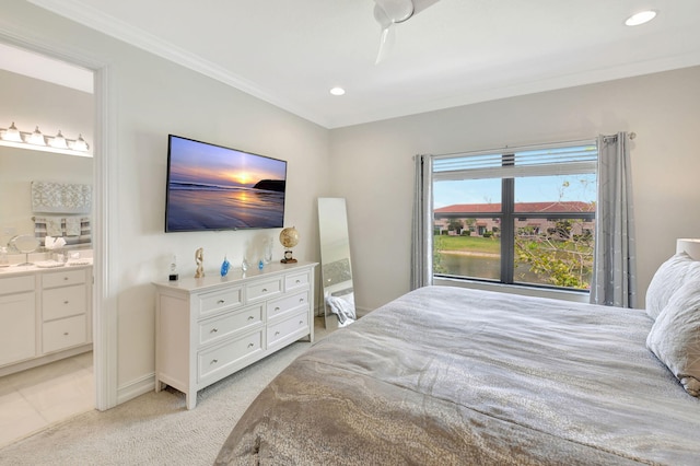 bedroom featuring ornamental molding, light colored carpet, recessed lighting, and connected bathroom