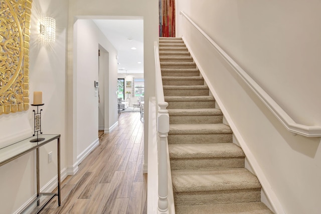stairs featuring recessed lighting, baseboards, and wood finished floors