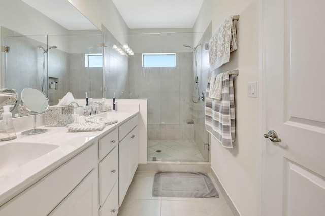 bathroom featuring double vanity, a sink, tile patterned floors, and a shower stall