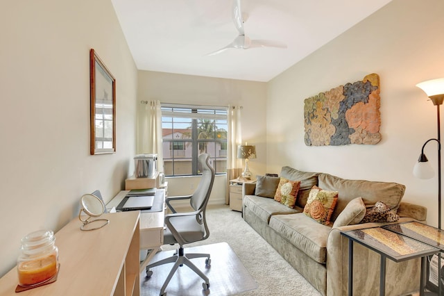office space featuring a ceiling fan and light carpet