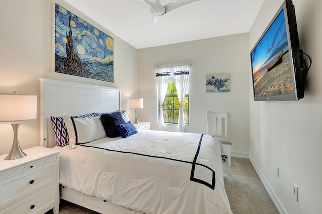 bedroom with baseboards and light colored carpet