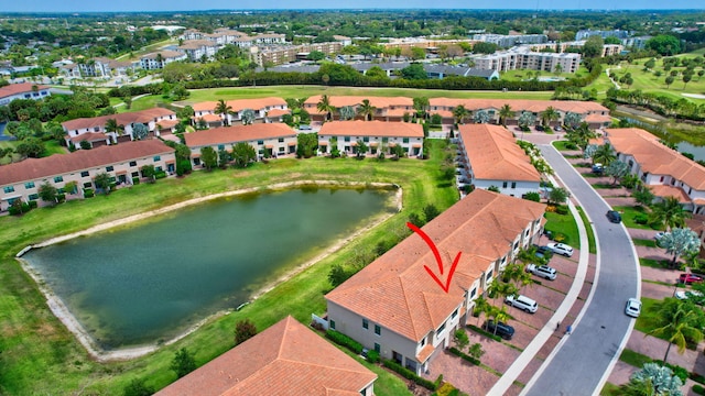 drone / aerial view with a water view and view of golf course