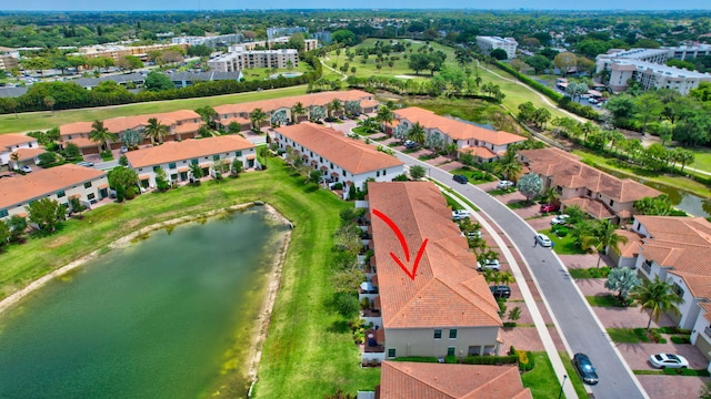 birds eye view of property featuring a water view and golf course view