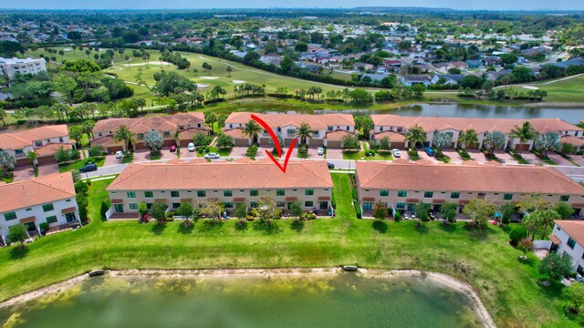bird's eye view featuring a water view, golf course view, and a residential view