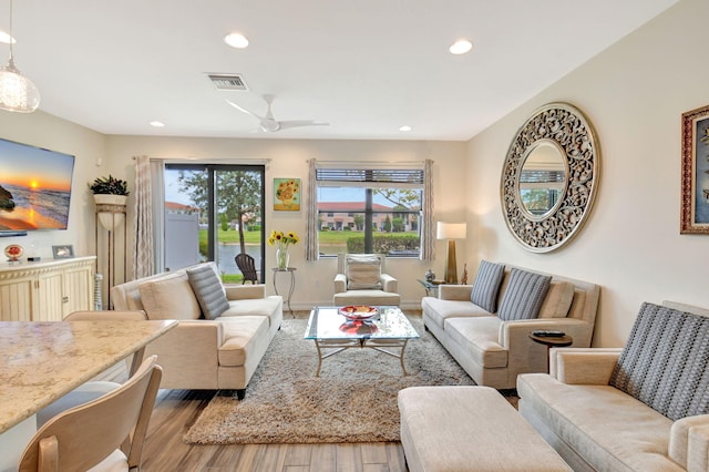 living room featuring recessed lighting, visible vents, and wood finished floors