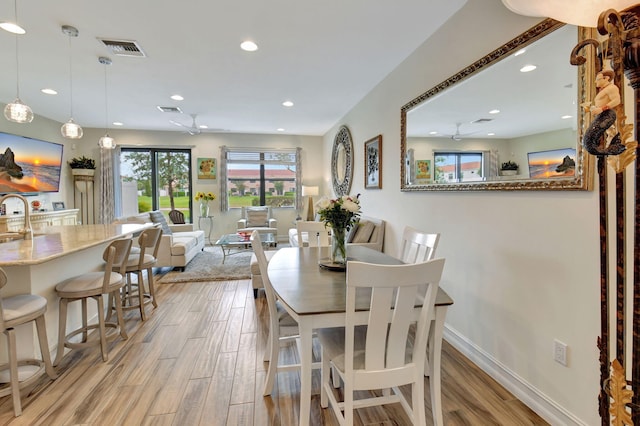 dining area featuring recessed lighting, light wood-style flooring, and visible vents
