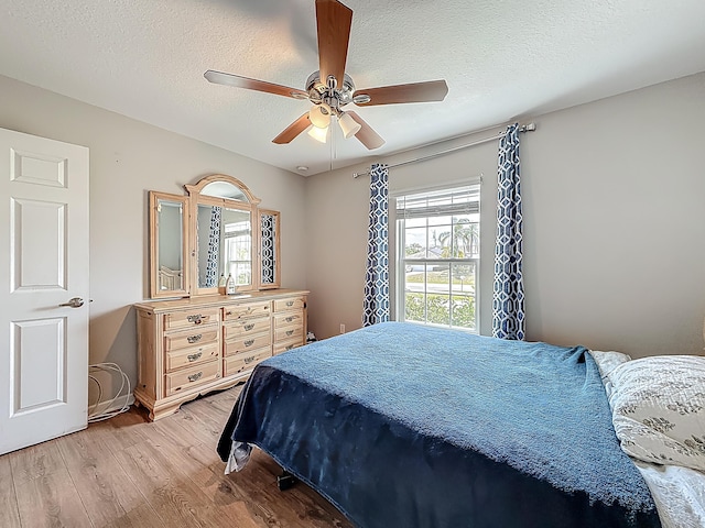 1679 SW Cameo Blvd, Port Saint Lucie, FL 34953 - bedroom featuring a textured ceiling, light wood-style floors, and ceiling fan