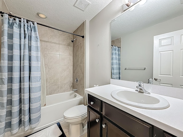 1679 SW Cameo Blvd, Port Saint Lucie, FL 34953 - bathroom featuring visible vents, toilet, vanity, shower / tub combo with curtain, and a textured ceiling