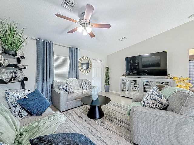1679 SW Cameo Blvd, Port Saint Lucie, FL 34953 - living area featuring vaulted ceiling, a ceiling fan, tile patterned floors, a textured ceiling, and visible vents