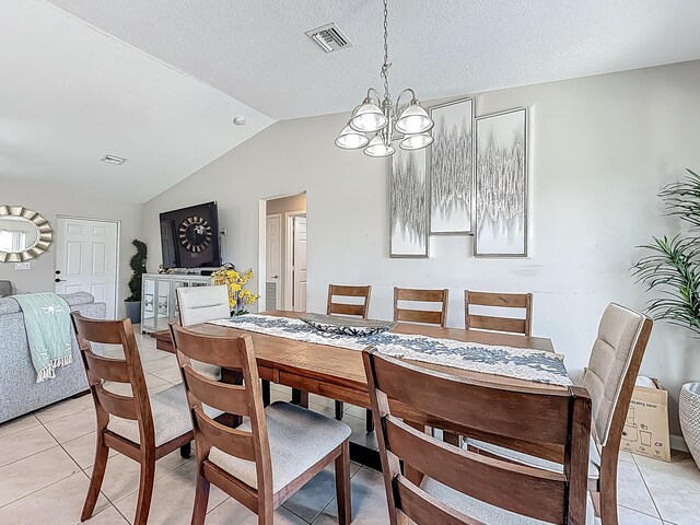 1679 SW Cameo Blvd, Port Saint Lucie, FL 34953 - dining space with lofted ceiling, visible vents, an inviting chandelier, and light tile patterned floors