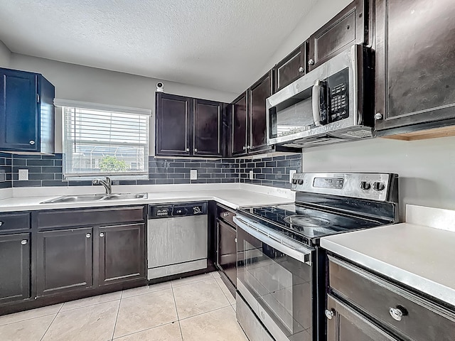 1679 SW Cameo Blvd, Port Saint Lucie, FL 34953 - kitchen featuring light countertops, a textured ceiling, stainless steel appliances, and a sink