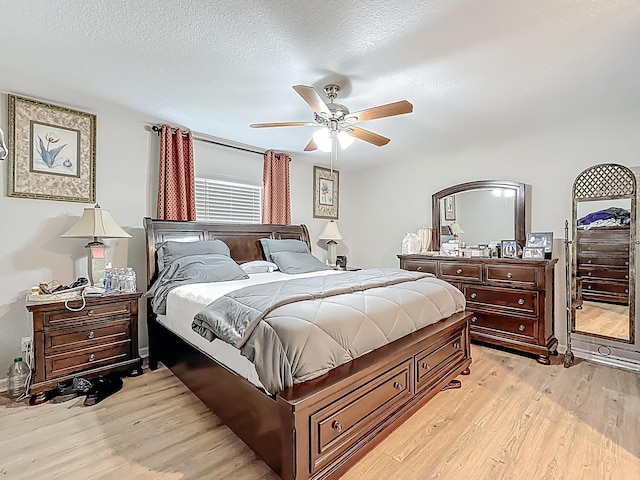 1679 SW Cameo Blvd, Port Saint Lucie, FL 34953 - bedroom featuring light wood-style flooring, a textured ceiling, and a ceiling fan