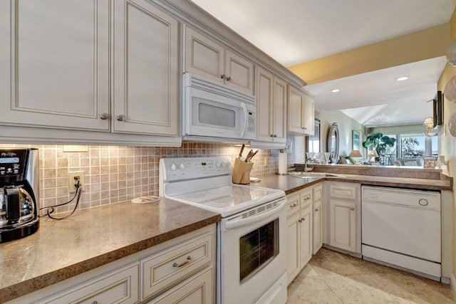 kitchen featuring recessed lighting, a sink, decorative backsplash, and white appliances
